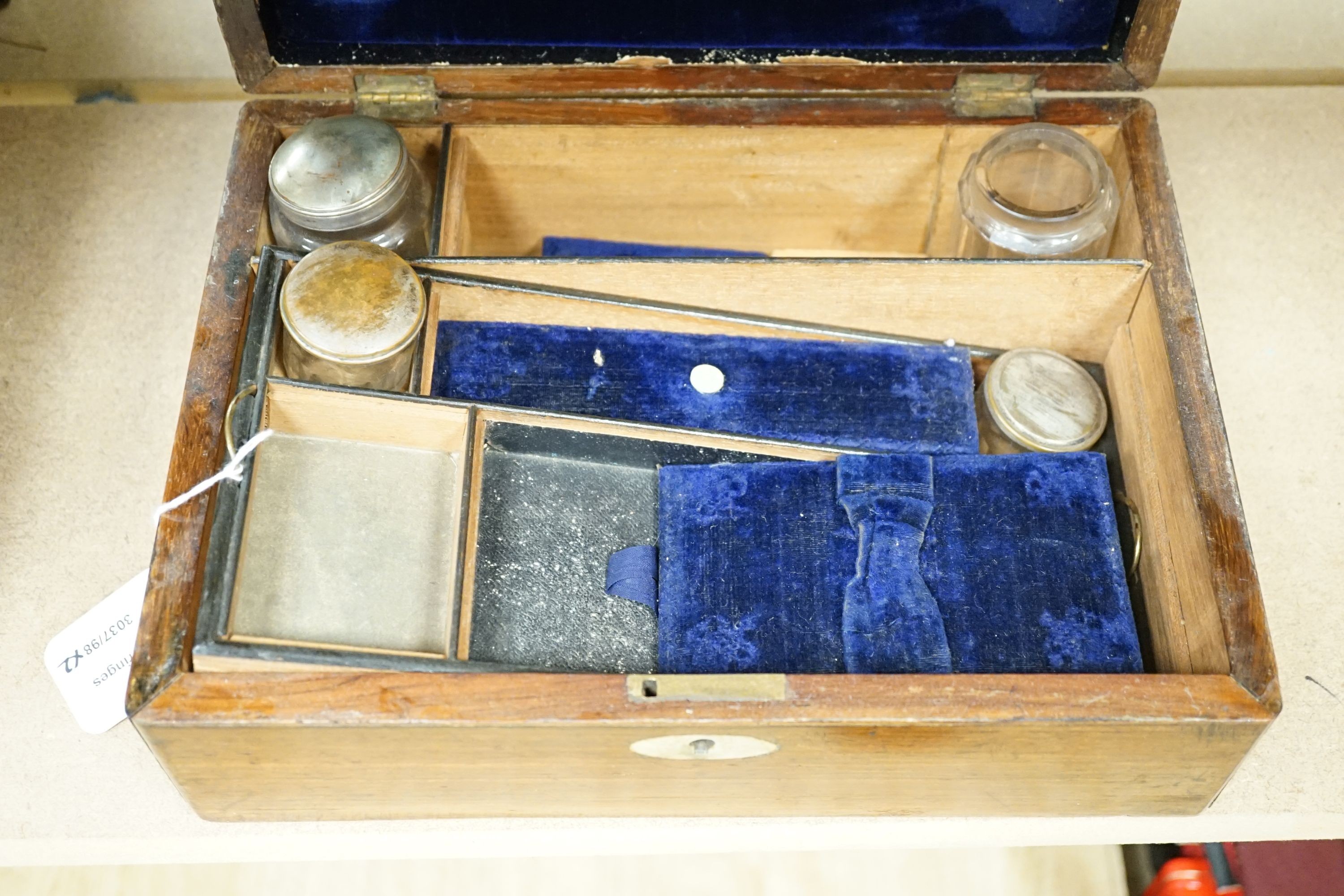 Two Victorian rosewood cased travelling vanity sets with silver plated covers (2)